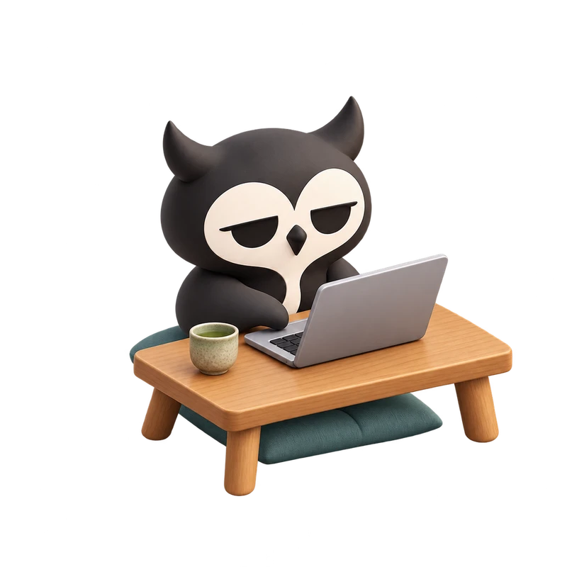 My sleepy owl mascot, building at a laptop with a cup of tea.